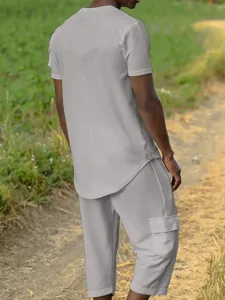 Men casual short sleeve t-shirt and cargo shorts set, outdoor detail view of summer outfit.