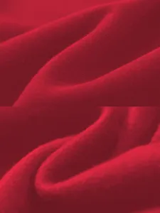 Red sweatshirt fabric detail shot showcasing soft knit texture and fine folds for autumn style.