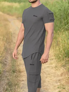 Detail view of men's dark gray short sleeve t-shirt and cargo pants set, casual outdoor wear.