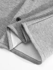 Gros plan detaille du tissu de chemise a manches longues jacquard gris coutures boutons.