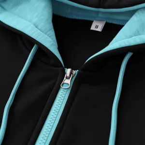Detail view of the black and turquoise zip-up hoodie, showing the collar label and zipper.