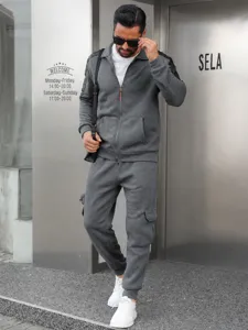 Detail view of men's grey tracksuit, zip-up collar jacket and cargo pants, casual wear.