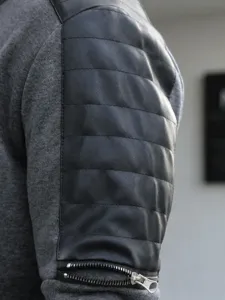 Close-up detail of men's casual jacket sleeve with quilted faux leather and zipper.