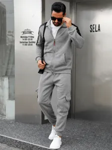Grey men's athletic tracksuit detail showing collar zip and cargo sweatpants style.