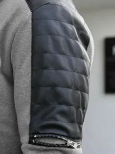 Men casual jacket detail view showing black PU leather quilted sleeve with metal zipper.