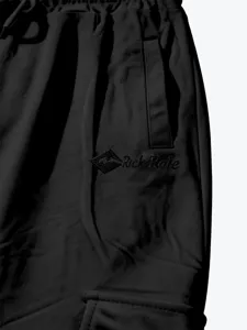 Detailed shot of men's cargo shorts featuring elastic drawstring waist and side pocket embroidery.