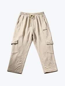 Detailed shot of beige casual cargo pants with elastic drawstring waist and multi-pockets.