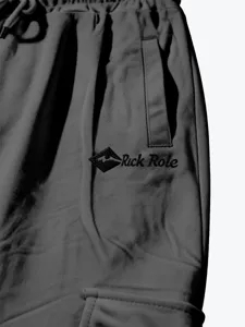 Detail shot of men's casual cargo pants featuring elastic drawstring waist and side pockets.