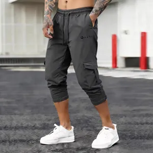 Men dark grey tactical cargo capri pants with elastic drawstring waist and multi pockets.