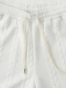 Knit shorts waist detail close up, white casual sportswear textured fabric drawstring.