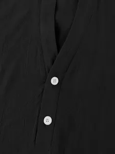 Close-up detail of men's casual solid color short sleeve shirt with white buttons.