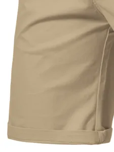 Detailed close-up shot of men's casual khaki shorts fabric and rolled cuff hem