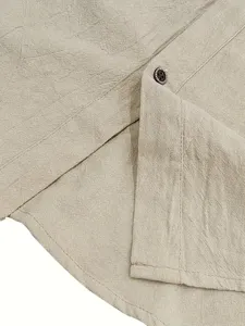 Close-up detail of men's casual linen shirt showing fabric texture, button and neat stitching.