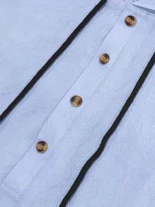 Detailed close-up view of casual men's summer linen clothing with contrast trim and buttons.