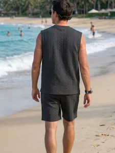 Mens knitwear vest shorts set detailed view showing textured jacquard fabric texture.
