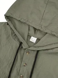 Close-up detail of green linen hoodie showing fabric texture and collar buttons.