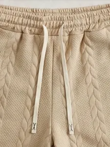 Men's casual shorts detail view showing knitted jacquard texture and adjustable drawstring waist.