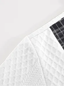 Close-up detail of men's casual sweatshirt featuring textured fabric and plaid patchwork.