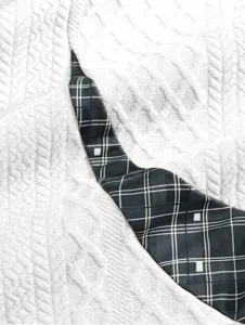Detail shot of men's casual hoodie fabric featuring white textured knit and dark plaid trim.