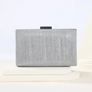 Elegant silver glitter evening clutch bag detail view, shimmering texture and chic clasp.