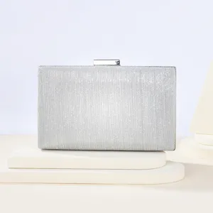 Silver glitter evening clutch bag with metallic clasp closure for women party detail view.