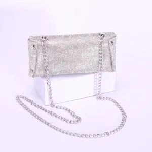 Sparkling rhinestone encrusted surface with delicate texture and shiny silver chain detail.