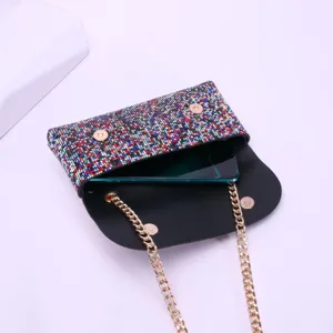 Sparkling rhinestone crossbody phone bag detail, elegant evening clutch with gold chain.