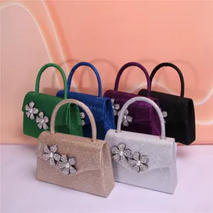 Sparkling glitter evening bag with double rhinestone flower and pearl details for party use.