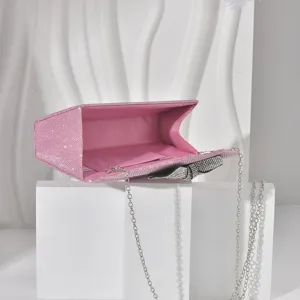 Pink rhinestone bow evening bag detail with sparkling crystals and silver chain for luxury style.