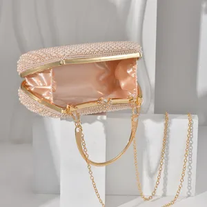 Elegant pearl evening clutch bag detail, gold-tone metal frame and satin lining design.