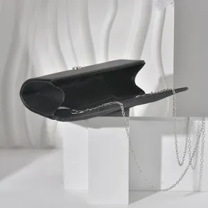 Black fine glitter evening clutch bag with silver chain strap for women parties dress details.