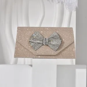Sparkling champagne gold evening clutch bag with rhinestone bow, elegant party crossbody bag.