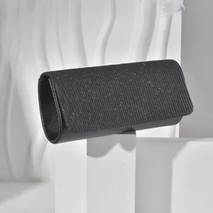 Detail view of black glitter evening clutch bag, elegant texture for party dress accessory.