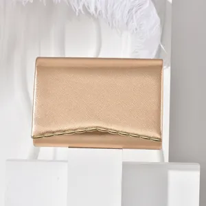Elegant rose gold clutch evening bag with metallic wave edge for women parties and weddings.