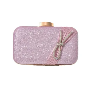 Pink glitter evening clutch bag with rhinestone bow and gold clasp for party and wedding