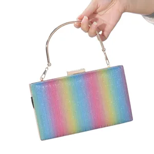Detailed view of a rainbow glitter evening clutch bag with elegant metal top handle.