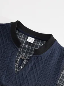 Men long sleeve sweatshirt collar detail, dark blue textured fabric with plaid inner lining.