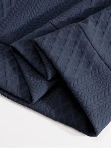 Men's dark blue sweatshirt fabric detail, featuring a stylish geometric texture and fine knitting.