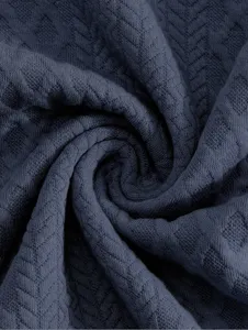 Men's sweatshirt fabric detail close-up, dark blue textured knit material, stylish casual style.
