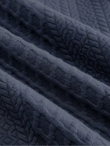 Detailed view of men's dark grey sweatshirt fabric with subtle geometric pattern.