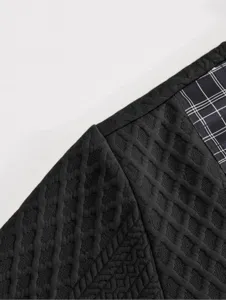 Detailed close-up shot of men's black textured long sleeve sweatshirt with stylish plaid panel.