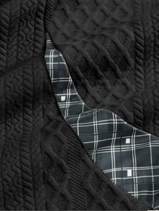 Men's sweatshirt detail showcasing black textured fabric combined with stylish plaid contrast trim.