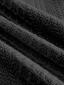 Detailed view of dark grey men's sweatshirt fabric featuring a fine textured knit.