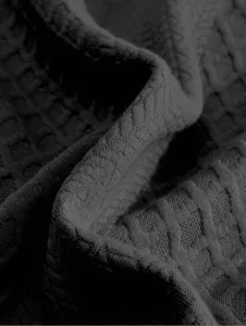 Detailed close-up of dark grey men's sweatshirt fabric featuring unique textured pattern.