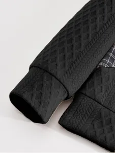 Detailed view of men's long sleeve sweatshirt cuff and plaid accent, stylish and modern top.