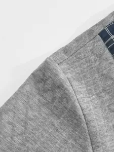 Men's casual long sleeve sweatshirt fabric detail, grey knit with plaid shoulder patch.