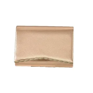 Rose gold evening clutch bag for women, elegant envelope purse with metallic trim.