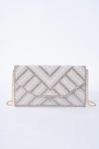 Close-up detail of the luxury pearl and rhinestone evening clutch bag with delicate chain.