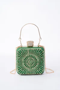 Green rhinestone evening clutch bag detail, sparkling crystals, metallic handle and chain.