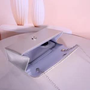 Silver evening bag with pearl chain and diamond details, elegant clutch for weddings and parties.